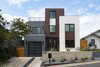 Modern home with Outdoor, Front Yard, Slope, Flowers, Raised Planters, Concrete Patio, Porch, Deck, Hardscapes, Wood Fences, Wall, and Metal Patio, Porch, Deck. Exterior View from Street Photo of East 9th House
