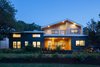 Modern home with Exterior, Metal Roof Material, Metal Siding Material, Wood Siding Material, and House Building Type. Exterior - Dusk Photo of Norris House