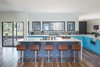 Modern home with Kitchen, Engineered Quartz Counter, Colorful Cabinet, Microwave, Ceiling Lighting, Medium Hardwood Floor, Glass Tile Backsplashe, Ceramic Tile Floor, Refrigerator, Undermount Sink, Wall Oven, and Cooktops. Kitchen Photo 3 of Norris House