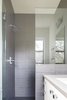 Modern home with Bath Room, Drop In Sink, Enclosed Shower, Engineered Quartz Counter, Ceiling Lighting, and Ceramic Tile Wall. Guest Bath Photo 12 of Norris House