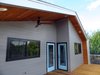Modern home with Exterior, House Building Type, Metal Roof Material, and Wood Siding Material. Upstairs Deck Photo 4 of Norris House