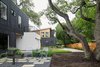 Modern home with Outdoor, Grass, Trees, Front Yard, Shrubs, Woodland, Raised Planters, Side Yard, Flowers, Gardens, Walkways, Pavers Patio, Porch, Deck, Hardscapes, Small Patio, Porch, Deck, Garden, Horizontal Fences, Wall, Wood Fences, Wall, Tile Patio, Porch, Deck, Stone Patio, Porch, Deck, and Concrete Patio, Porch, Deck. ADU (left) and House (background) Photo 2 of Chelsea ADU