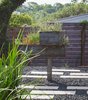 Modern home with Outdoor, Raised Planters, Planters Patio, Porch, Deck, Front Yard, Metal Patio, Porch, Deck, Pavers Patio, Porch, Deck, Horizontal Fences, Wall, Trees, and Wood Fences, Wall. Custom Steel Planter, fabricated by Davey McEathron Architecture Photo 8 of Chelsea ADU