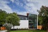 Modern home with Exterior, House Building Type, Flat RoofLine, Shed RoofLine, Wood Siding Material, Metal Roof Material, and Stucco Siding Material. Exterior - Front Photo of Chelsea House