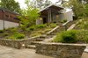 Low basalt stone walls lead to the home's entry at the upper terrace. Photo 2 of Cedar Mills House modern home
