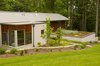 The garage features a green roof accessible from a side yard entry. Photo 4 of Cedar Mills House modern home