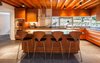 The kitchen features Mahogany cabinetry, dark granite counters and counter height windows with views towards the backyard. Photo 7 of Cedar Mills House modern home