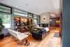 A full height fireplace intersects the barrel vaulted ceiling between the living and dining areas. Photo 9 of Cedar Mills House modern home