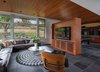The family room features Mahogany cabinetry housing all the family's electronics, separating the tv viewing area from the billiards table. Photo 10 of Cedar Mills House modern home