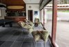 A series of full panel sliding glass doors open the family room to the pool terrace. Photo 11 of Cedar Mills House modern home