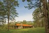 In autumn, the mineral rust color of the standing seam metal roof blends the home into the canopy of surrounding oaks. Photo of Columbia Gorge House modern home