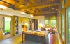 The Great Room features trusses crafted of antique hand hewn timbers. Salvaged barn wood and local stone surround the fireplace. Photo 5 of Columbia Gorge House modern home