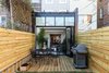 Rear deck with open atrium seamlessly extends the indoor space into the outdoor space Photo 4 of Brooklyn Railroad Townhouse to Open Plan Renovation modern home