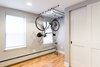 Hanging bike storage installed to create more floor space in foyer Photo 4 of Jersey City Basement to Entertainment Renovation modern home