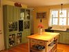 Modern home with Kitchen, Wood Counter, Colorful Cabinet, Wood Cabinet, Medium Hardwood Floor, Recessed Lighting, Pendant Lighting, Dishwasher, and Vessel Sink. Kitchen Photo 3 of The McCullough Project