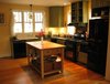 Modern home with Kitchen, Wood Cabinet, Colorful Cabinet, Medium Hardwood Floor, Pendant Lighting, Microwave, Refrigerator, Stone Tile Backsplashe, Recessed Lighting, Range, Vessel Sink, Range Hood, Dishwasher, and Wood Counter. Kitchen Photo 4 of The McCullough Project