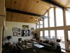 Modern home with Living Room, Lamps, Pendant Lighting, Dark Hardwood Floor, Recessed Lighting, Sofa, Chair, Table, and Coffee Tables. We added a door, replaced a few broken-seal units, and added tongue and groove pine ceiling and beam wrap to this 2-story living room with loft. Photo 7 of The McCarthy Project