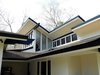 Modern home with Exterior, Hipped RoofLine, Wood Siding Material, Gable RoofLine, Shed RoofLine, Shingles Roof Material, and House Building Type. Exterior right of house near carport and side entry into new mudroom. Photo 11 of The McCarthy Project