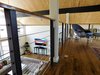 Modern home with Dark Hardwood Floor and Chair. View from loft down to living. Photo 19 of The McCarthy Project