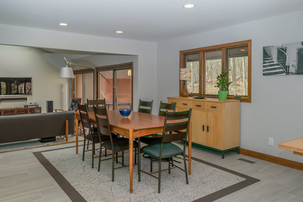 The space transitions smoothly from entertaining in the formal dining area...