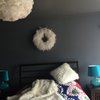 The home owners like to have a calm and quiet bedroom. The dark gray wall color provides exact that. White feather pendent and feather shawl with pillows contrast the dark gray wall and add comfort and coziness to the room. Photo 16 of The Bubbles House modern home