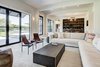 Modern home with Living Room, Sofa, Chair, Ottomans, Coffee Tables, End Tables, Recessed Lighting, Ceiling Lighting, Rug Floor, and Light Hardwood Floor. Living room with floor to ceiling windows. Photo 2 of Jagger Lane