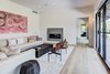 Modern home with Living Room, End Tables, Coffee Tables, Sofa, Ottomans, Sectional, Chair, Recessed Lighting, Ceiling Lighting, Gas Burning Fireplace, Rug Floor, Light Hardwood Floor, and Two-Sided Fireplace. Living room with see-through fireplace. Photo 3 of Jagger Lane