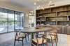 Modern home with Dining Room, Chair, Storage, Ceiling Lighting, Table, Pendant Lighting, Shelves, Light Hardwood Floor, and Rug Floor. Dining room with integrated millwork. Photo 4 of Jagger Lane