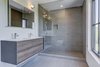 Modern home with Bath Room, Engineered Quartz Counter, Open Shower, Ceramic Tile Floor, Wall Mount Sink, Ceramic Tile Wall, and One Piece Toilet. Guest bathroom. Photo 6 of Jagger Lane