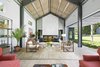 Modern home with Living Room, Coffee Tables, End Tables, Sofa, Chair, Ottomans, Console Tables, Bookcase, Ceiling Lighting, Track Lighting, Light Hardwood Floor, Two-Sided Fireplace, and Ribbon Fireplace. Main House Great Room with One of Two Fireplaces Photo of North Haven Compound