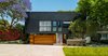 The design of this Pacific Palisades home was driven by the neighborhood's hillside ordinance. After studying various versions of the property, the architects decided that by dropping the street facade by four feet, they would be able to achieve a more linear design. A rooftop deck allows the homeowners to enjoy panoramic views of the Pacific Ocean. Photo 3 of The Middle House modern home