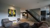 Beyond the stair stack is the kitchen and eating nook to the right and dining room to the left. Also located on this floor are a bathroom and office/playroom. Photo 3 of Eave House modern home