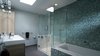 The master bathroom gains light through the skylight as well as morning light through windows on the east side. Photo 9 of Eave House modern home