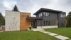The walkway leading up to the front doors is inviting and the different materials provide a fun variance of color that isn't too over the top. Photo of Modern Courtyard Home modern home