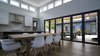Natural light permeates the kitchen through the many windows and glass doors, brightening the room that often becomes the center of all activity for this family. Photo 4 of Modern Courtyard Home modern home