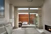 The master suite boasts two bathrooms, one of which is outside. Photo 7 of The Cape modern home