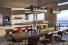 The open layout seamlessly connects kitchen, dining, and living spaces. Photo 5 of The Cape modern home