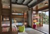 Garage-style doors open and connect the children's rooms to the outdoors. Photo 10 of The Cape modern home
