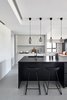 Modern home with Kitchen, Concrete Floor, Pendant Lighting, and White Cabinet. Kitchen Photo 2 of Blackened Wood Apartment