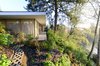 Set on an urban in-fill lot at the edge of a terrace escarpment overlooking protected wetlands and a wild river, the Courtyard House weaves between natural and urban contexts. Photo of The Courtyard House modern home