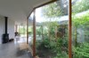 The faceted exterior glass courtyard introduces nature into daily life. Photo 7 of The Courtyard House modern home