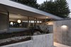 Entered through a sunken patio, the house flows in a continuous loop around two L-shaped storage cores. Photo 8 of The Courtyard House modern home