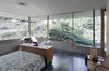A stepped glass and concrete envelope negotiates transparency and privacy to the neighboring context. Photo 9 of The Courtyard House modern home