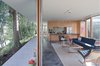 A matrix of rooms separate and connect around the L-shaped bathroom and storage cores made flexible by concealed doors at their ends. Photo 10 of The Courtyard House modern home