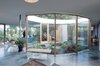 The Courtyard House nurtures inter-generational family life, framed by nature: a gentle entrance ramp and exterior covered terrace, negotiable for wheelchair, walker, or stroller, connects inside to out. Photo 14 of The Courtyard House modern home