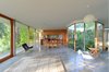The kitchen replaces daily overhead cabinets with large drawers to directly connect sink and dishes, while the showers are curb-less and roll-in. Photo 15 of The Courtyard House modern home