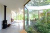 In the wintertime, the courtyard’s position increases the passive heating of the sun, while in the summertime, shaded by native deciduous trees, the courtyard stimulates natural ventilation and passive cooling. Photo 16 of The Courtyard House modern home