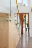 Modern home with Staircase, Glass Railing, and Wood Tread. Maple wood and glass staircase detail Photo 2 of Upgraded A-game