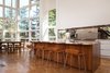Modern home with Kitchen and Mirror Backsplashe. Island countertop and mirrored backsplash are the decorative elements in the minimally ornamented space. Photo 4 of Skyline to the Sea House