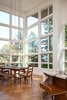 Modern home with Dining Room. Kitchen and dining area getting plenty of light from two-story high windows. Photo 5 of Skyline to the Sea House